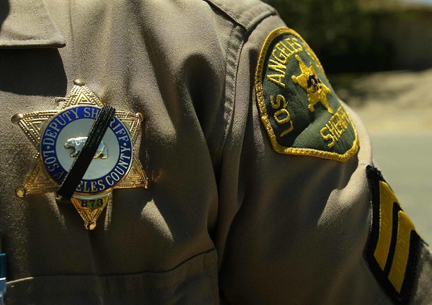 An Officer with the Los Angeles County Sheriff's Department who knew Sorensen wears a black band ove 
