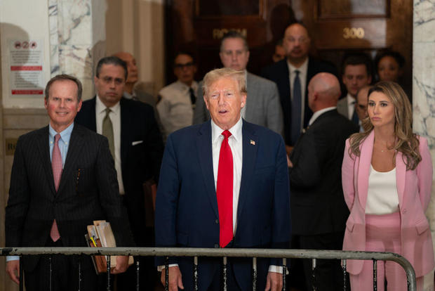 Flanked by his attorneys, former President Donald Trump speaks to the media while attending his trial in New York State Supreme Court on Dec. 7, 2023. 