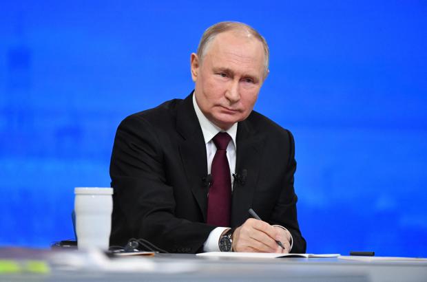 A pool photograph distributed by Russia's state agency Sputnik shows Russian President Vladimir Putin holding his year-end press conference at Gostiny Dvor exhibition hall in central Moscow on December 14, 2023. 
