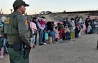 Migrants attempting to cross into the U.S. from Mexico are detained by U.S. Customs and Border Protection at the border Dec. 14, 2023, in Jacumba Hot Springs, California. 