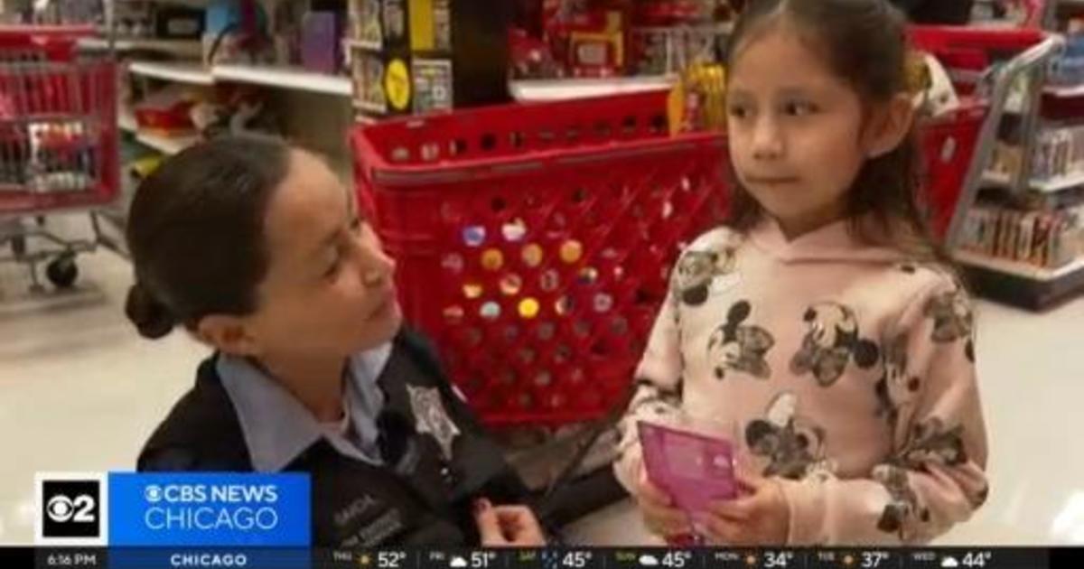 An officer and migrant child bond Shop With A Cop event - CBS Chicago