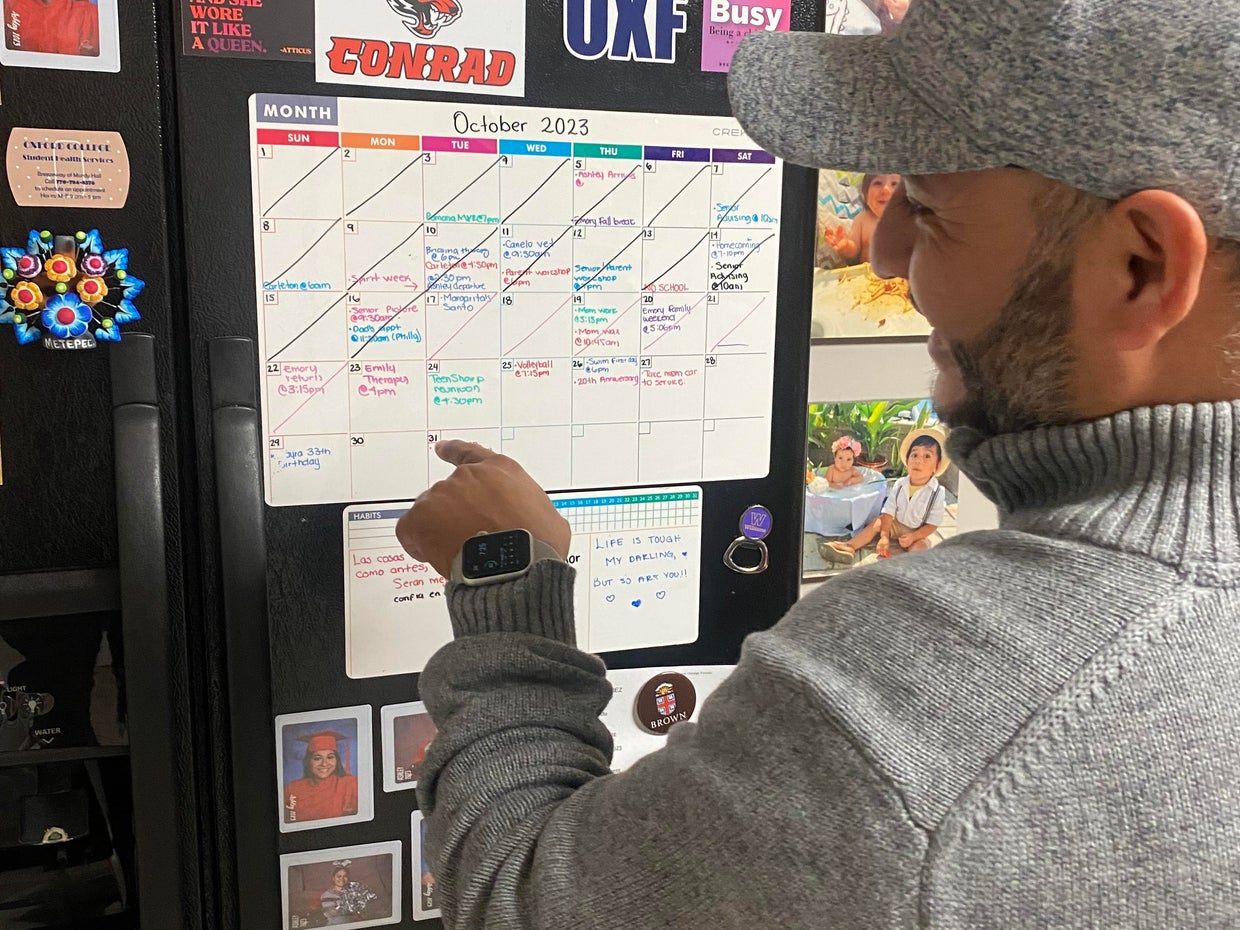 Rafael Rodriguez checks the family calendar