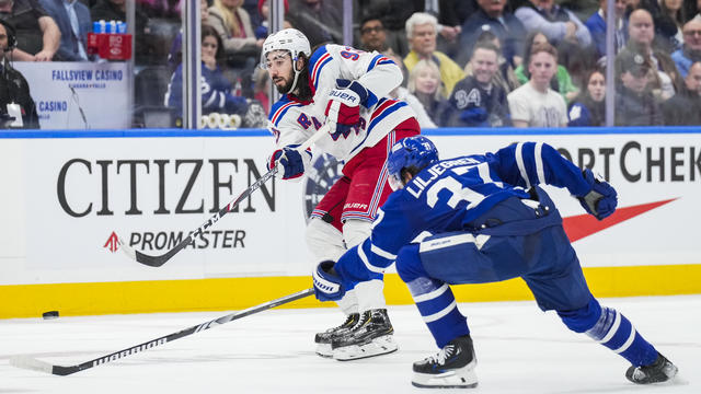Mika Zibanejad #93 of the New York Rangers play the puck against Timothy Liljegren #37 of the Toronto Maple Leafs during the third period at Scotiabank Arena on December 19, 2023 in Toronto, Ontario, Canada. 