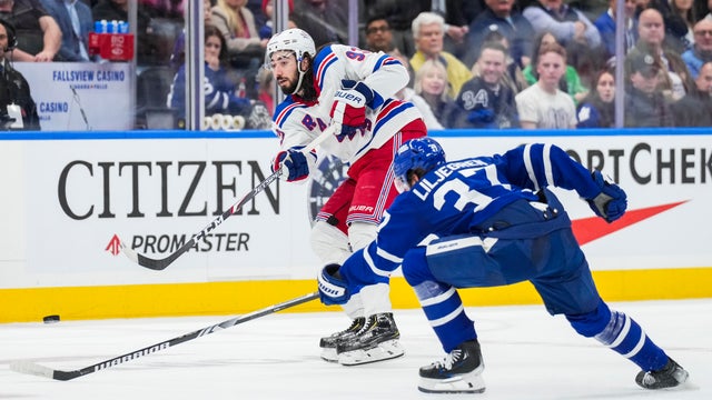 Mika Zibanejad #93 of the New York Rangers play the puck against Timothy Liljegren #37 of the Toronto Maple Leafs during the third period at Scotiabank Arena on December 19, 2023 in Toronto, Ontario, Canada.