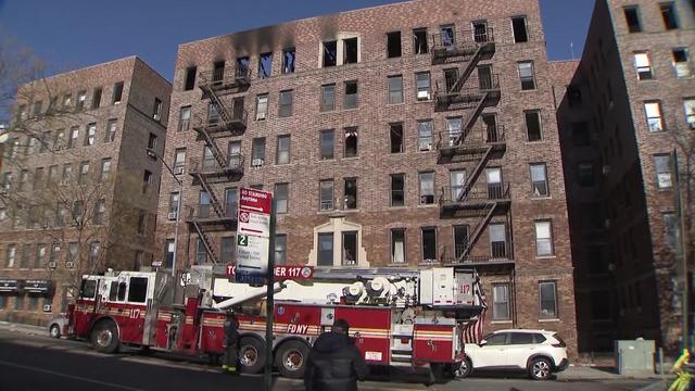 Flames can be seen shooting through the roof of a Queens apartment building. 