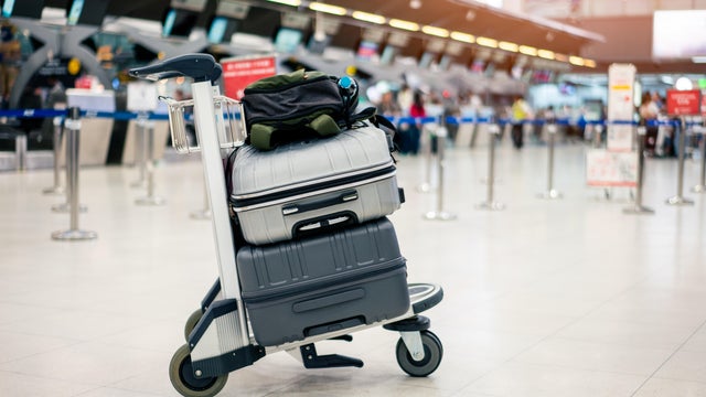 Suitcase or baggage with airport luggage trolley in the international airport. 