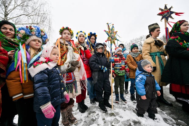 Children, wearing traditional Ukrainian outfits, take part in Christmas celebrations in the village of Pyrogove, near Kyiv, on Dec. 25, 2023