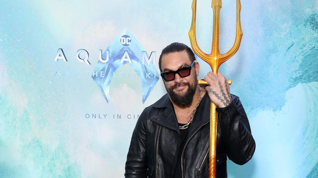 Actor Jason Momoa holds a trident at an event for his new film, "Aquaman and the Lost Kingdom" 
