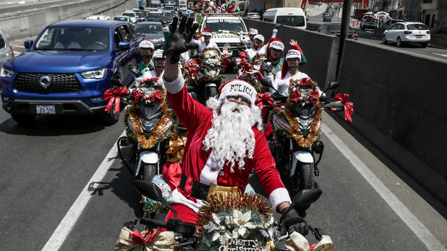 Police officers from the traffic squad in Christmas costumes walk through the streets of Lima 