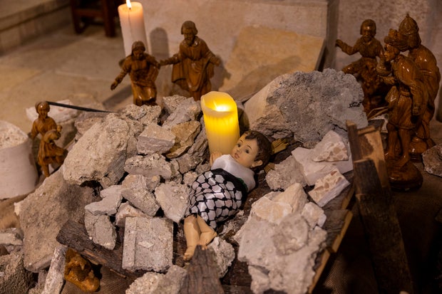 A Nativity scene at the Evangelical Lutheran Christmas Church in Bethlehem, in the West Bank, shows baby Jesus wrapped in a keffiyeh and surrounded by rubble to show solidarity with the people of Gaza, on Dec. 24, 2023
