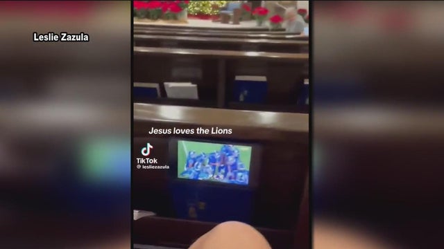 Detroit Lions fans caught sneaking a peek at the game during Christmas Eve mass
