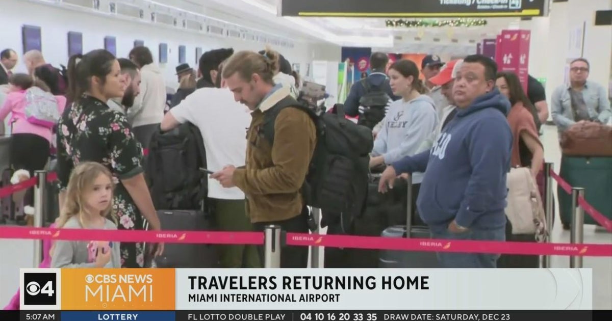 Travelers at Miami International Airport braved the crowds as they tried out to get to their spot