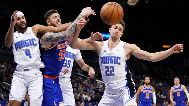 Isaiah Hartenstein #55 of the New York Knicks competes for a rebound against Franz Wagner #22 of the Orlando Magic during the first quarter at Kia Center on December 29, 2023 in Orlando, Florida.