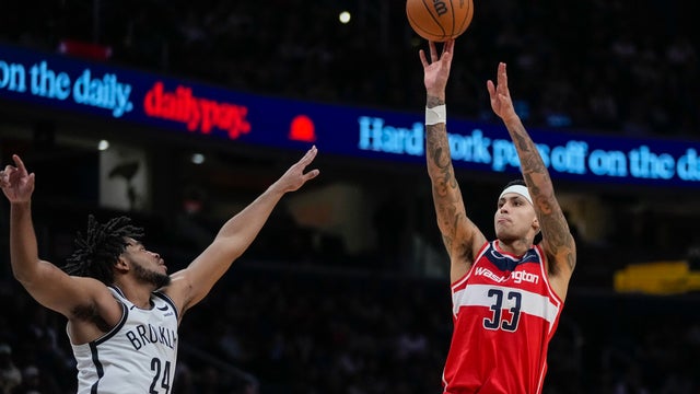 Washington Wizards forward Kyle Kuzma (33) shoots over Brooklyn Nets guard Cam Thomas (24) during the second half of an NBA basketball game Friday, Dec. 29, 2023, in Washington.