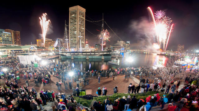 Fireworks shooting off of barge during New Years Eve celebration at Baltimore's Inner Harbor. The Constellation is seen in the middle.The location is Baltimore, Maryland, USA 