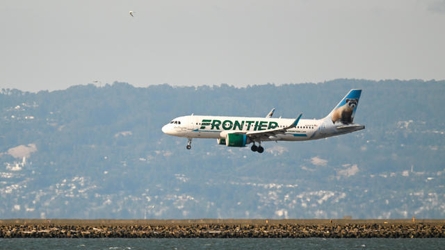A Frontier Airlines plane lands 