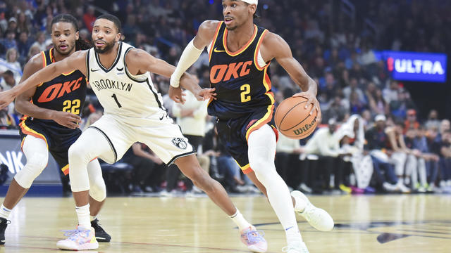 Oklahoma City Thunder guard Shai Gilgeous-Alexander (2) drives past Brooklyn Nets forward Mikal Bridges (1) in the first half of an NBA basketball game, Sunday, Dec. 31, 2023, in Oklahoma City. 