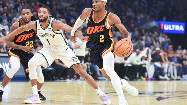 Oklahoma City Thunder guard Shai Gilgeous-Alexander (2) drives past Brooklyn Nets forward Mikal Bridges (1) in the first half of an NBA basketball game, Sunday, Dec. 31, 2023, in Oklahoma City.