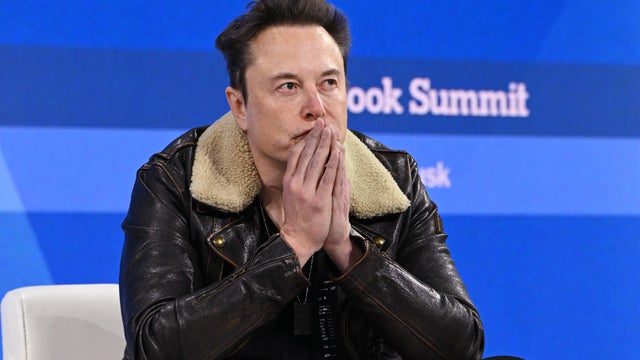 Elon Musk speaks onstage during The New York Times Dealbook Summit