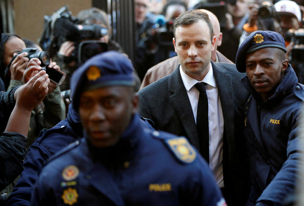 FILE PHOTO: FILE PHOTO: Oscar Pistorius is escorted by police officers as he arrives for his sententencing for the 2013 murder of his girlfriend Reeva Steenkamp, at North Gauteng High Court in Pretoria, South Africa 