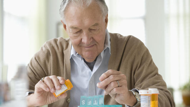 Elderly man taking  daily medicine 
