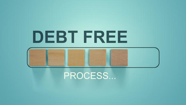 Finance conceptual, Business concept: Woodblocks with the word Debt Free in the loading bar progress. Depicts repayment planning and money management. To increase financial liquidity to pay off debt. 