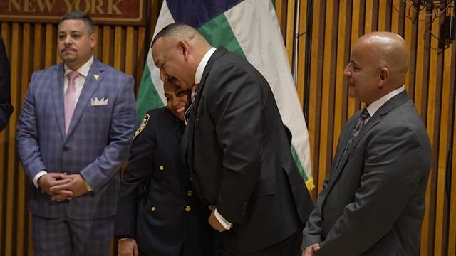 Former NYPD detective Eric Ocasio hugs NYPD Officer Denise Gomez as former detective Charles Claudio looks on. 