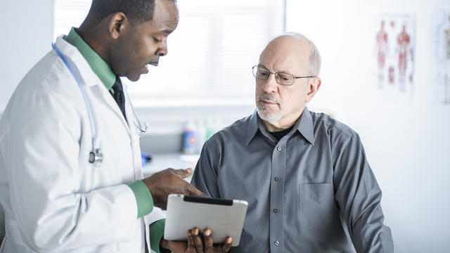 African American doctor talking to patient in office 