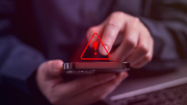 People with warning notification and spam message icon on mobile phone 