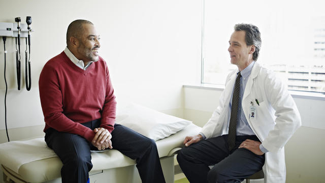 Mature male patient in discussion with doctor 