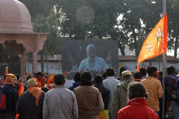 Hindu devotees watch on a big screen as India's Prime Minister Narendra Modi attends the inauguration of the Hindu Lord Ram temple, in Ayodhya, India, Jan. 22, 2024