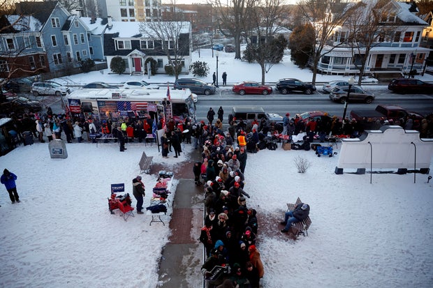Trump supporters wait in line ahead of a campaign rally in Rochester, New Hampshire.