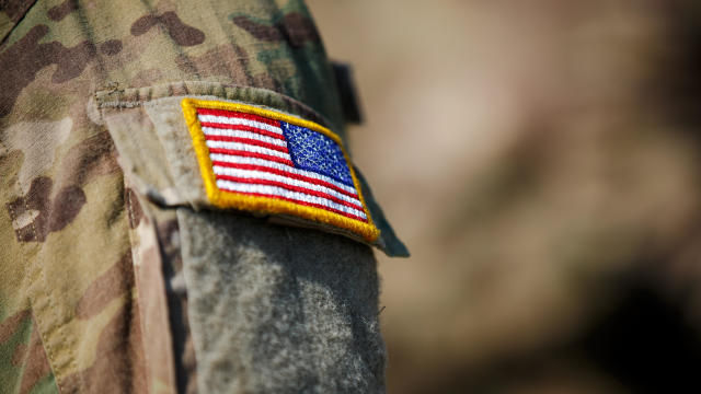 American flag and US Army patch on solder's uniform 