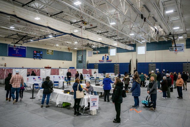 People stand in line in preparation to cast their ballots in the New Hampshire primary at Londonderry High School on Jan. 23, 2024, in Londonderry, New Hampshire.