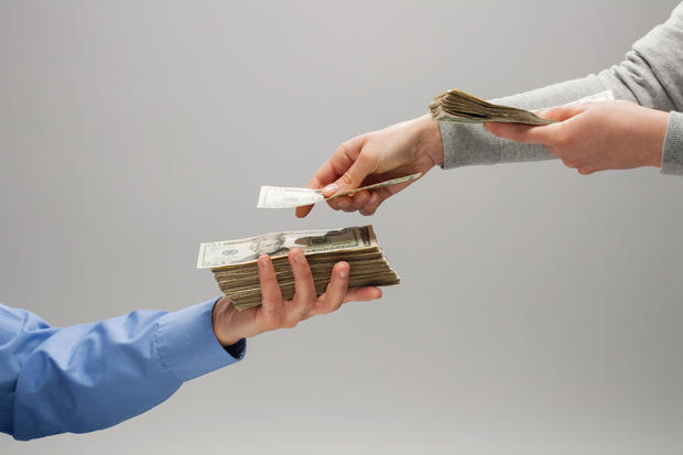 Girl handing man money