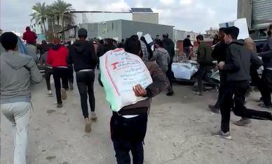 A screengrab from video obtained by Reuters shows Palestinians running away from a humanitarian aid distribution point in Gaza City, Jan. 25, 2024, amid the sound of gunfire