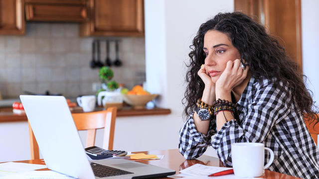 Worried woman sitting at home 