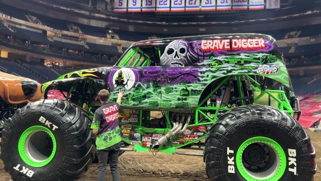 Weston Anderson closes the driver's side door on his monster truck, Grave Digger. 