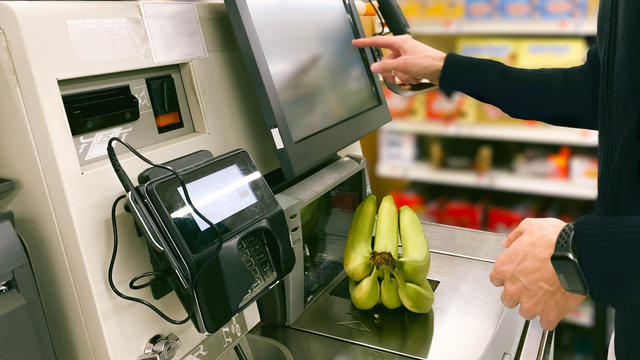 Man Purchases Bananas at Self-Checkout Kiosk 