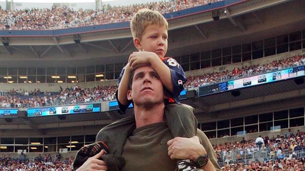 Ed McCaffrey and his son Christian watch first quarter action from the sideline during the Denver Broncos 31-20 victory over the New England Patriots. (craig f walker/ the denver post) 10/28/01 