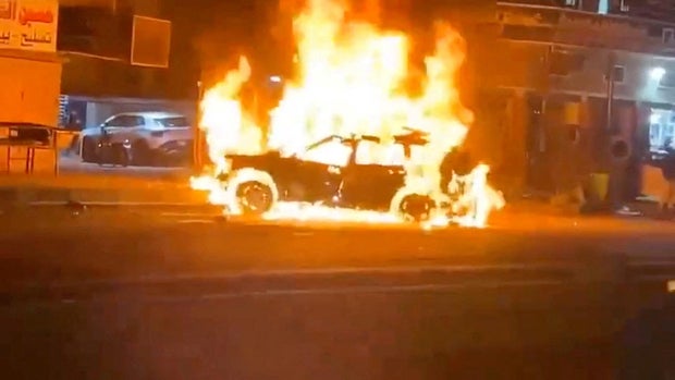 A car burns following what the U.S. military says was a deadly drone strike on a Kataib Hezbollah commander, in Baghdad, Iraq, Feb. 7, 2024, in this screengrab from social media video obtained by Reuters.