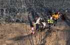 An aerial view shows migrants walking next to razor wire after crossing the Rio Grande to seek asylum at sunset in Eagle Pass, Texas, on Feb. 4, 2024. 