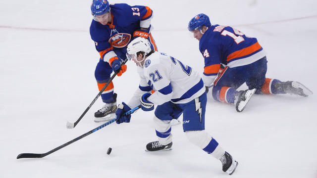New York Islanders Center Mathew Barzal (13) and New York Islanders Center Bo Horvat (14) and Tampa Bay Lightning Center Brayden Point (21) battle for the puck during the first period of the National Hockey League game between the Tampa Bay Lightning and 