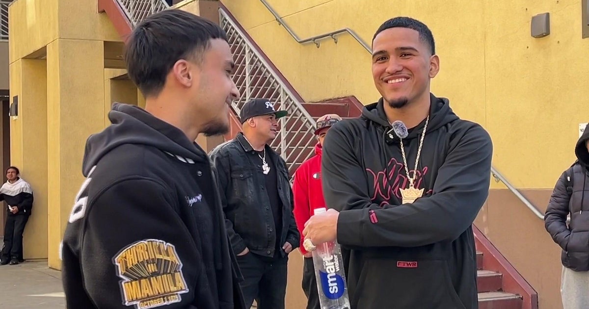 Pro boxer Gabriel Flores Jr. hands out tickets to students in return to Stockton alma mater