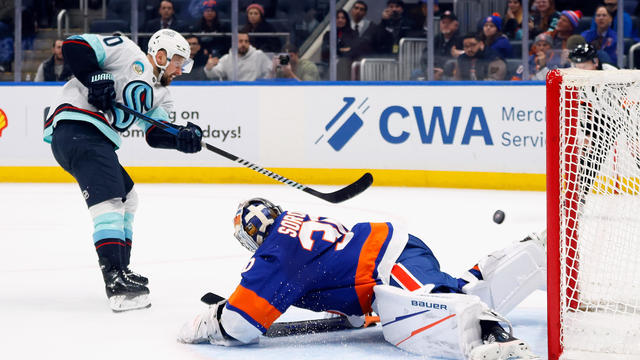 Tomas Tatar #90 of the Seattle Kraken scores the game-winning goal in the shootout against Ilya Sorokin #30 of the New York Islanders at UBS Arena on February 13, 2024 in Elmont, New York. 