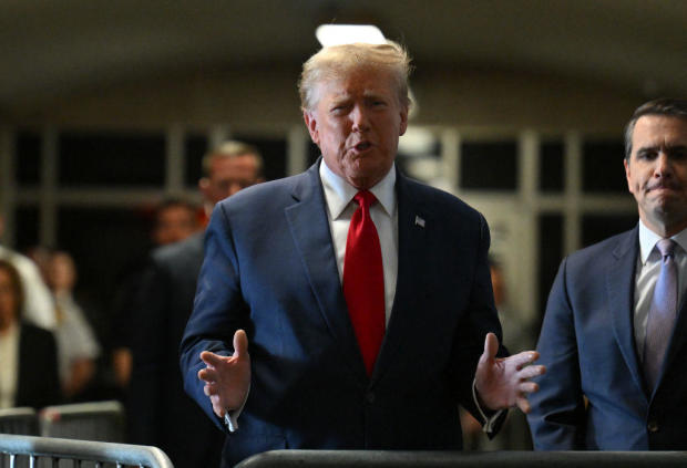 Former President Donald Trump speaks to the press as he arrives at Manhattan Criminal Court on Thursday, Feb. 15, 2024. 