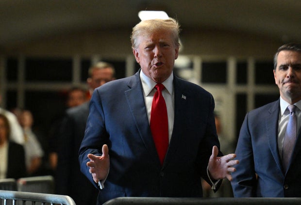 Former President Donald Trump speaks to the press as he arrives at Manhattan Criminal Court on Thursday, Feb. 15, 2024.