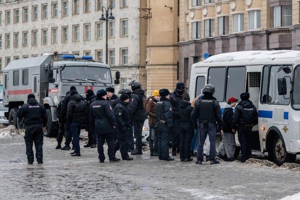 Police in St. Petersburg detain people after laying flowers at the Memorial to Victims of Political Repression to honor Russian opposition leader Alexei Navalny on Saturday, Feb. 17, 2024.