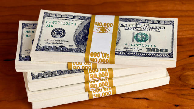 $50,000 in US $100 Bills on a Cherry Desk 