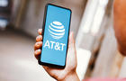 In this photo illustration, the AT&T logo is displayed on a 